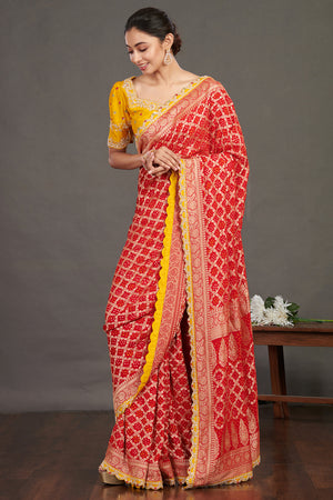 Buy red embroidered bandhej sari online in USA with yellow blouse. Make a fashion statement on festive occasions and weddings with designer sarees, designer suits, Indian dresses, Anarkali suits, palazzo suits, designer gowns, sharara suits, embroidered sarees from Pure Elegance Indian fashion store in USA.-front