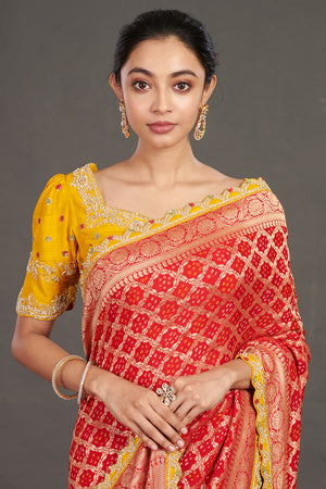 Buy red embroidered bandhej sari online in USA with yellow blouse. Make a fashion statement on festive occasions and weddings with designer sarees, designer suits, Indian dresses, Anarkali suits, palazzo suits, designer gowns, sharara suits, embroidered sarees from Pure Elegance Indian fashion store in USA.-closeup