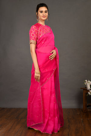 Shop pink embroidered organza sari online in USA with bandhej blouse. Make a fashion statement on festive occasions and weddings with designer sarees, designer suits, Indian dresses, Anarkali suits, palazzo suits, designer gowns, sharara suits, embroidered sarees from Pure Elegance Indian fashion store in USA.-side