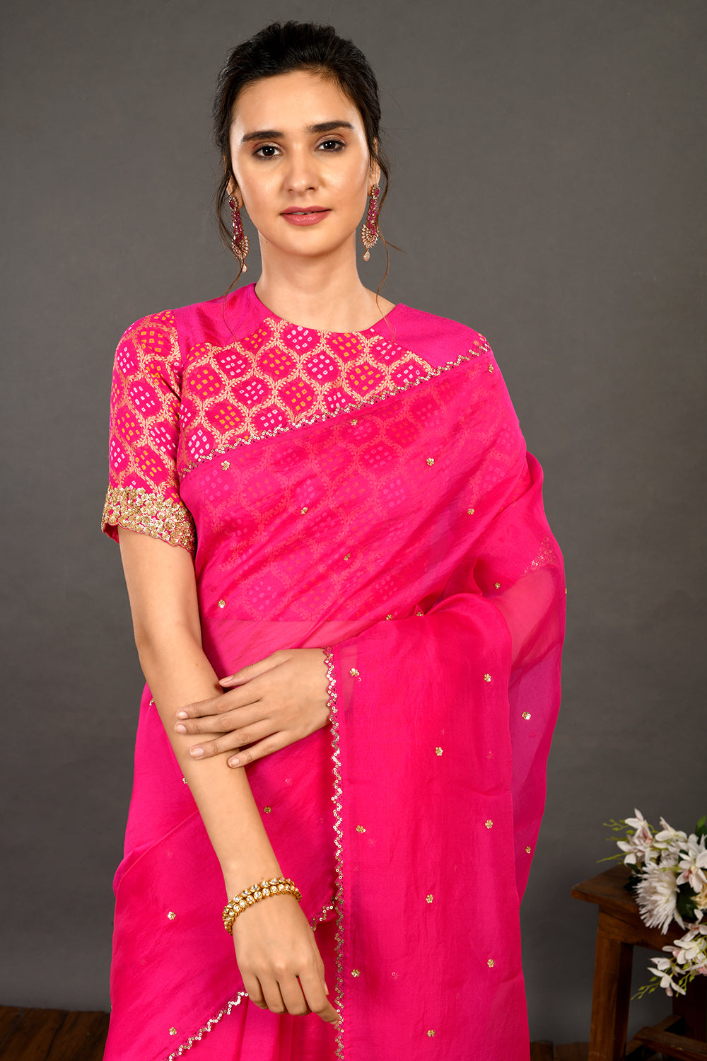 Shop pink embroidered organza sari online in USA with bandhej blouse. Make a fashion statement on festive occasions and weddings with designer sarees, designer suits, Indian dresses, Anarkali suits, palazzo suits, designer gowns, sharara suits, embroidered sarees from Pure Elegance Indian fashion store in USA.-closeup