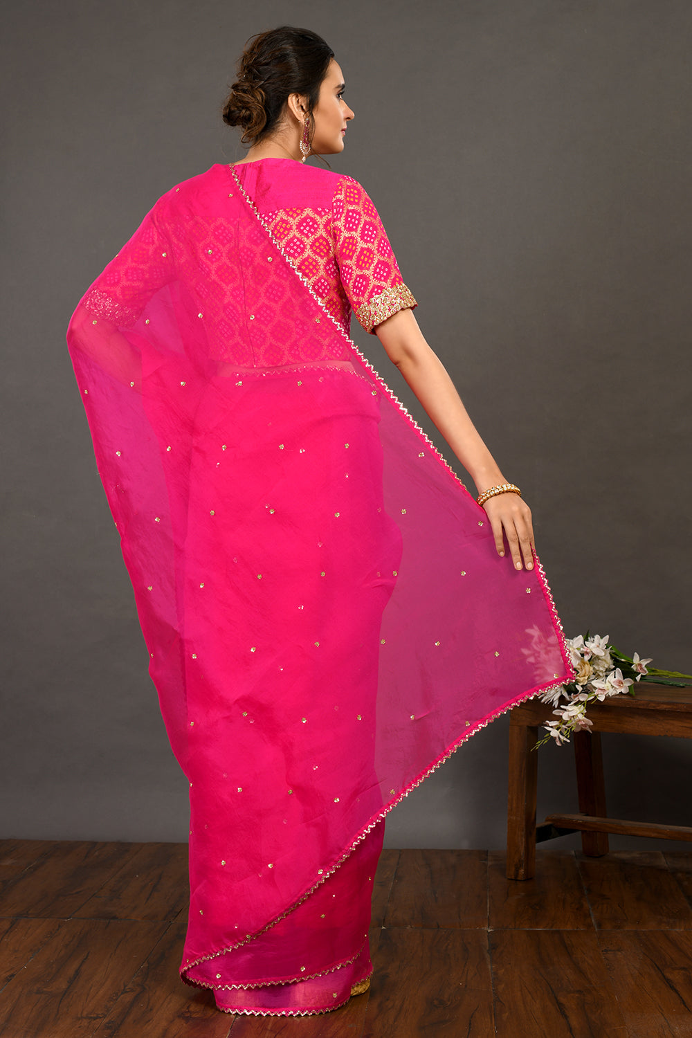 Shop pink embroidered organza sari online in USA with bandhej blouse. Make a fashion statement on festive occasions and weddings with designer sarees, designer suits, Indian dresses, Anarkali suits, palazzo suits, designer gowns, sharara suits, embroidered sarees from Pure Elegance Indian fashion store in USA.-back