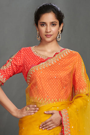Shop mustard embroidered organza sari online in USA with orange blouse. Make a fashion statement on festive occasions and weddings with designer sarees, designer suits, Indian dresses, Anarkali suits, palazzo suits, designer gowns, sharara suits, embroidered sarees from Pure Elegance Indian fashion store in USA.-closeup