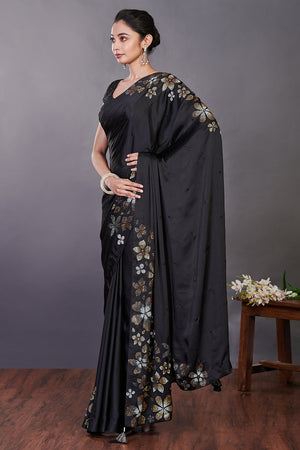 Shop black Swarovski floral motifs satin sari online in USA with blouse. Make a fashion statement on festive occasions and weddings with designer sarees, designer suits, Indian dresses, Anarkali suits, palazzo suits, designer gowns, sharara suits, embroidered sarees from Pure Elegance Indian fashion store in USA.-pallu