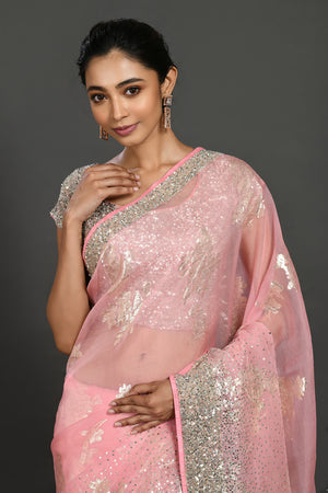 Buy light pink cutdana and stone work organza sari online in USA with blouse. Make a fashion statement on festive occasions and weddings with designer sarees, designer suits, Indian dresses, Anarkali suits, palazzo suits, designer gowns, sharara suits, embroidered sarees from Pure Elegance Indian fashion store in USA.-closeup