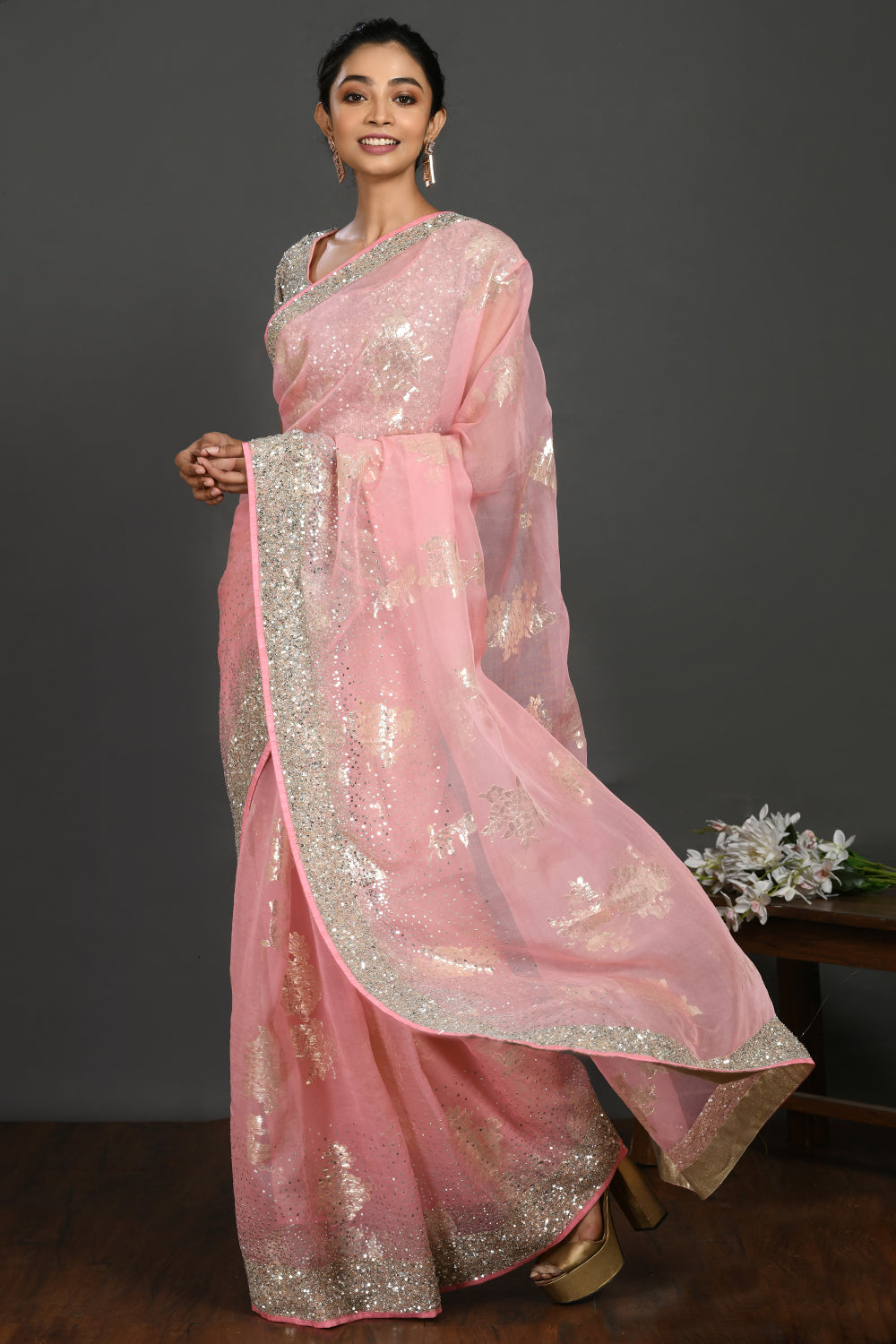 Buy light pink cutdana and stone work organza sari online in USA with blouse. Make a fashion statement on festive occasions and weddings with designer sarees, designer suits, Indian dresses, Anarkali suits, palazzo suits, designer gowns, sharara suits, embroidered sarees from Pure Elegance Indian fashion store in USA.-pallu