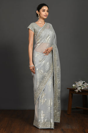 Shop doctor blue cutdana and stone work organza sari online in USA with blouse. Make a fashion statement on festive occasions and weddings with designer sarees, designer suits, Indian dresses, Anarkali suits, palazzo suits, designer gowns, sharara suits, embroidered sarees from Pure Elegance Indian fashion store in USA.-right