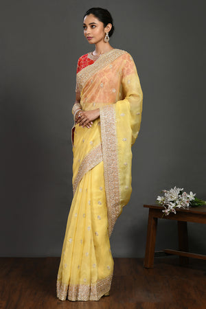 Buy yellow embroidered organza sari online in USA with red blouse. Make a fashion statement on festive occasions and weddings with designer sarees, designer suits, Indian dresses, Anarkali suits, palazzo suits, designer gowns, sharara suits, embroidered sarees from Pure Elegance Indian fashion store in USA.-side