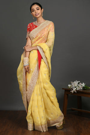 Buy yellow embroidered organza sari online in USA with red blouse. Make a fashion statement on festive occasions and weddings with designer sarees, designer suits, Indian dresses, Anarkali suits, palazzo suits, designer gowns, sharara suits, embroidered sarees from Pure Elegance Indian fashion store in USA.-front