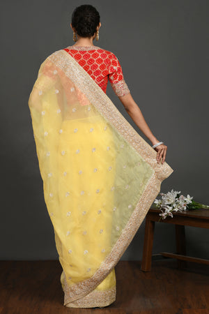 Buy yellow embroidered organza sari online in USA with red blouse. Make a fashion statement on festive occasions and weddings with designer sarees, designer suits, Indian dresses, Anarkali suits, palazzo suits, designer gowns, sharara suits, embroidered sarees from Pure Elegance Indian fashion store in USA.-back