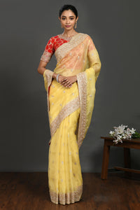 Buy yellow embroidered organza sari online in USA with red blouse. Make a fashion statement on festive occasions and weddings with designer sarees, designer suits, Indian dresses, Anarkali suits, palazzo suits, designer gowns, sharara suits, embroidered sarees from Pure Elegance Indian fashion store in USA.-full view