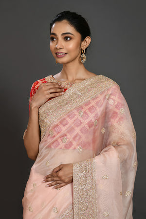 Buy powder pink embroidered organza sari online in USA with red blouse. Make a fashion statement on festive occasions and weddings with designer sarees, designer suits, Indian dresses, Anarkali suits, palazzo suits, designer gowns, sharara suits, embroidered sarees from Pure Elegance Indian fashion store in USA.-closeup