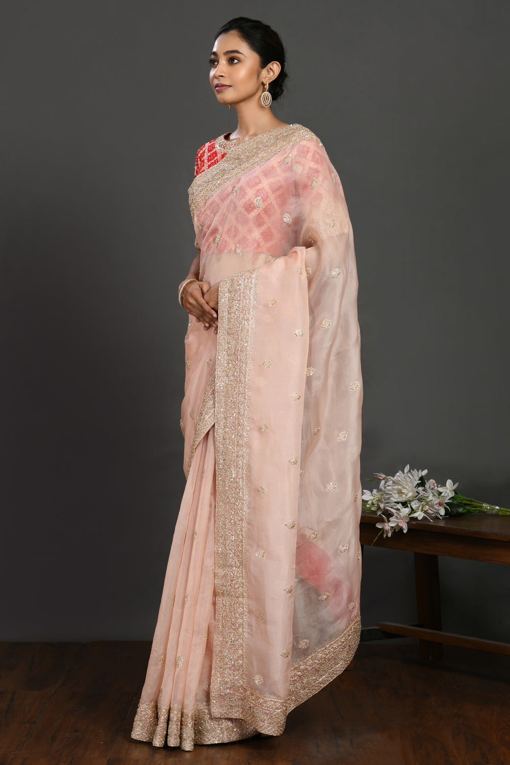 Buy powder pink embroidered organza sari online in USA with red blouse. Make a fashion statement on festive occasions and weddings with designer sarees, designer suits, Indian dresses, Anarkali suits, palazzo suits, designer gowns, sharara suits, embroidered sarees from Pure Elegance Indian fashion store in USA.-pallu