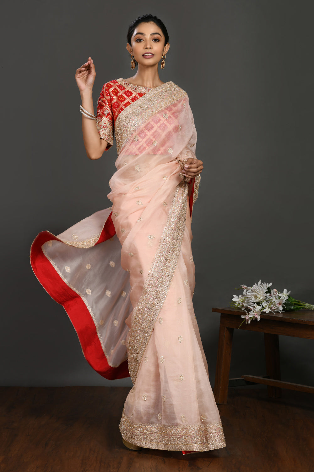 Buy powder pink embroidered organza sari online in USA with red blouse. Make a fashion statement on festive occasions and weddings with designer sarees, designer suits, Indian dresses, Anarkali suits, palazzo suits, designer gowns, sharara suits, embroidered sarees from Pure Elegance Indian fashion store in USA.-front