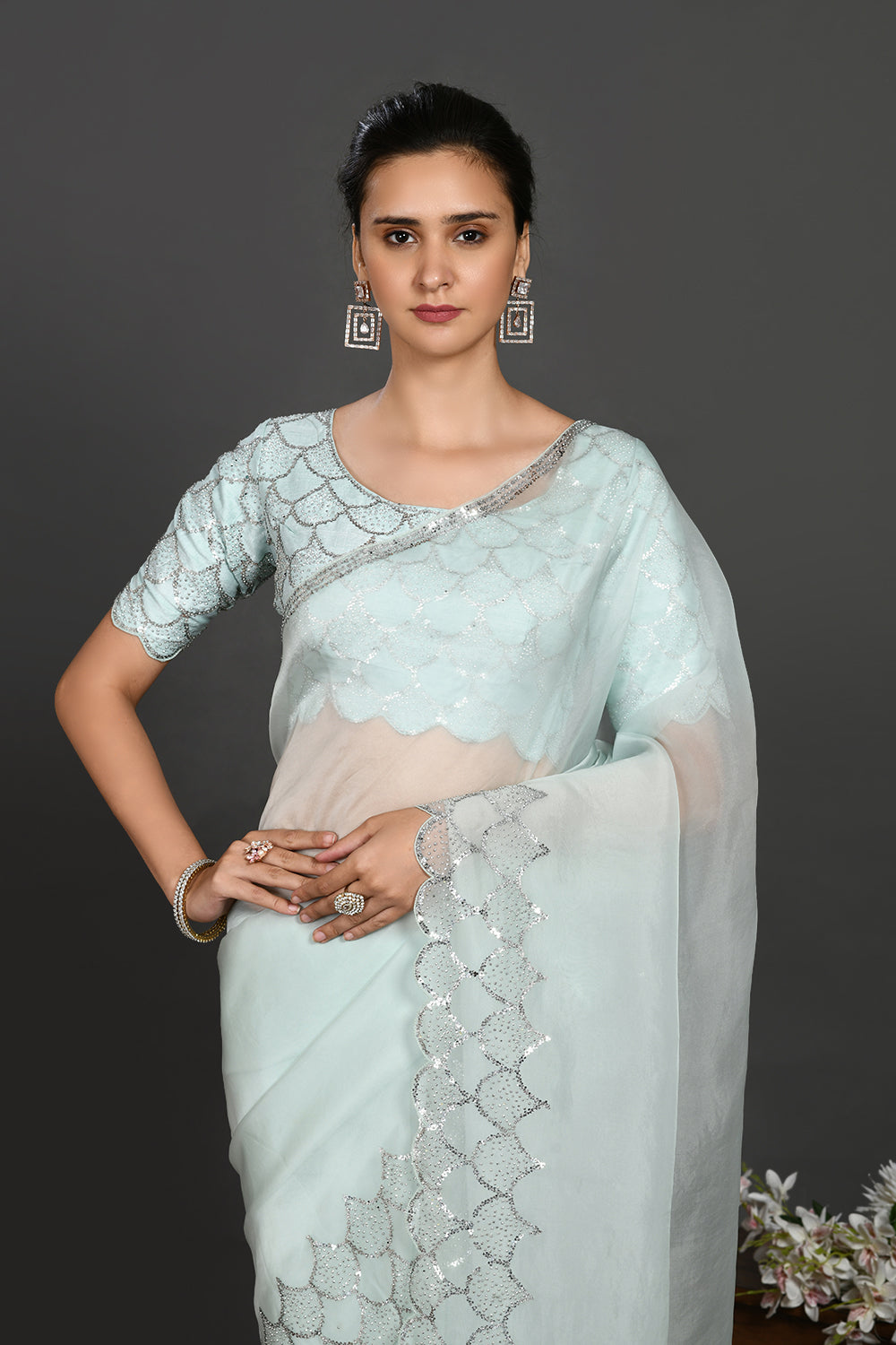 Shop aqua blue stone and sequin work organza sari online in USA. Make a fashion statement on festive occasions and weddings with designer sarees, designer suits, Indian dresses, Anarkali suits, palazzo suits, designer gowns, sharara suits, embroidered sarees from Pure Elegance Indian fashion store in USA.-closeup