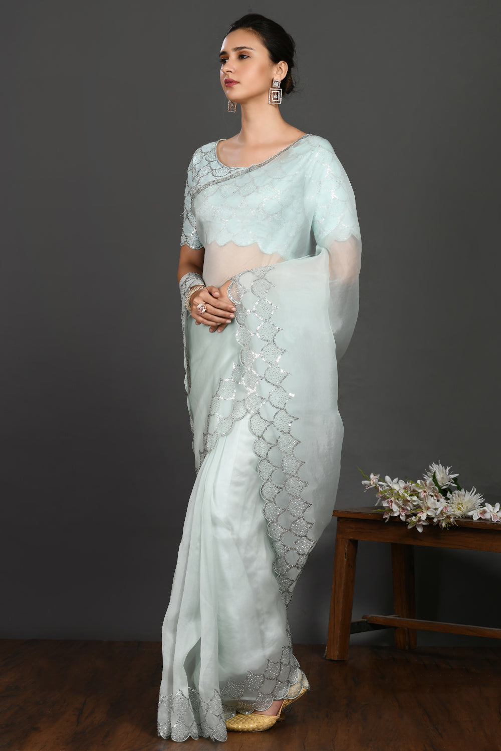Shop aqua blue stone and sequin work organza sari online in USA. Make a fashion statement on festive occasions and weddings with designer sarees, designer suits, Indian dresses, Anarkali suits, palazzo suits, designer gowns, sharara suits, embroidered sarees from Pure Elegance Indian fashion store in USA.-pallu