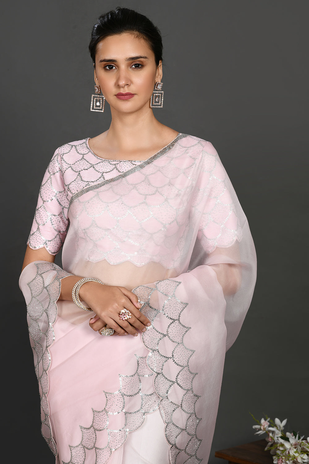 Buy powder pink stone and sequin work organza sari online in USA. Make a fashion statement on festive occasions and weddings with designer sarees, designer suits, Indian dresses, Anarkali suits, palazzo suits, designer gowns, sharara suits, embroidered sarees from Pure Elegance Indian fashion store in USA.-closeup