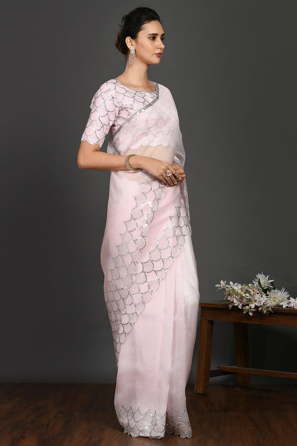 Buy powder pink stone and sequin work organza sari online in USA. Make a fashion statement on festive occasions and weddings with designer sarees, designer suits, Indian dresses, Anarkali suits, palazzo suits, designer gowns, sharara suits, embroidered sarees from Pure Elegance Indian fashion store in USA.-right