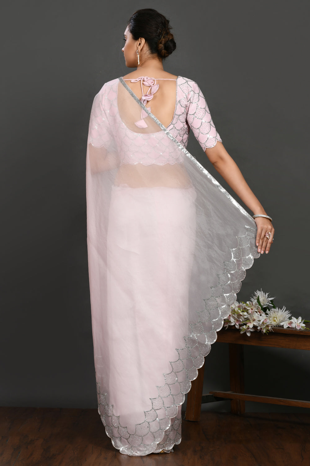 Buy powder pink stone and sequin work organza sari online in USA. Make a fashion statement on festive occasions and weddings with designer sarees, designer suits, Indian dresses, Anarkali suits, palazzo suits, designer gowns, sharara suits, embroidered sarees from Pure Elegance Indian fashion store in USA.-back