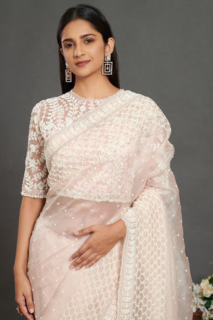 Shop powder pink embroidered organza saree online in USA with lace border. Make a fashion statement on festive occasions and weddings with designer sarees, designer suits, Indian dresses, Anarkali suits, palazzo suits, designer gowns, sharara suits, embroidered sarees from Pure Elegance Indian fashion store in USA.-closeup