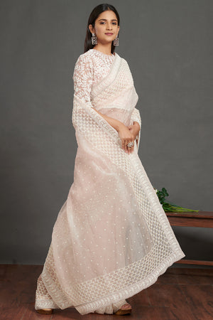 Shop powder pink embroidered organza saree online in USA with lace border. Make a fashion statement on festive occasions and weddings with designer sarees, designer suits, Indian dresses, Anarkali suits, palazzo suits, designer gowns, sharara suits, embroidered sarees from Pure Elegance Indian fashion store in USA.-right