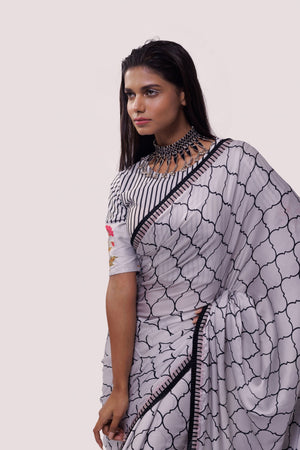 Shop white and black printed handloom saree online in USA with blouse. Make a fashion statement on festive occasions and weddings with designer sarees, designer suits, Indian dresses, Anarkali suits, palazzo suits, designer gowns, sharara suits, embroidered sarees from Pure Elegance Indian fashion store in USA.-closeup