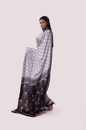 Shop white and black printed handloom saree online in USA with blouse. Make a fashion statement on festive occasions and weddings with designer sarees, designer suits, Indian dresses, Anarkali suits, palazzo suits, designer gowns, sharara suits, embroidered sarees from Pure Elegance Indian fashion store in USA.-pallu