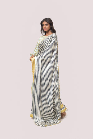 Shop white and black stripes satin saree online in USA with mint green blouse. Make a fashion statement on festive occasions and weddings with designer sarees, designer suits, Indian dresses, Anarkali suits, palazzo suits, designer gowns, sharara suits, embroidered sarees from Pure Elegance Indian fashion store in USA.-pallu