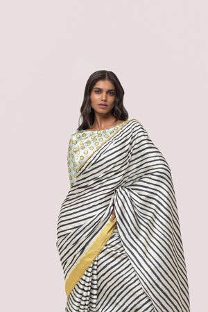 Shop white and black stripes satin saree online in USA with mint green blouse. Make a fashion statement on festive occasions and weddings with designer sarees, designer suits, Indian dresses, Anarkali suits, palazzo suits, designer gowns, sharara suits, embroidered sarees from Pure Elegance Indian fashion store in USA.-closeup