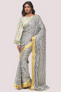 Shop white and black stripes satin saree online in USA with mint green blouse. Make a fashion statement on festive occasions and weddings with designer sarees, designer suits, Indian dresses, Anarkali suits, palazzo suits, designer gowns, sharara suits, embroidered sarees from Pure Elegance Indian fashion store in USA.-full view