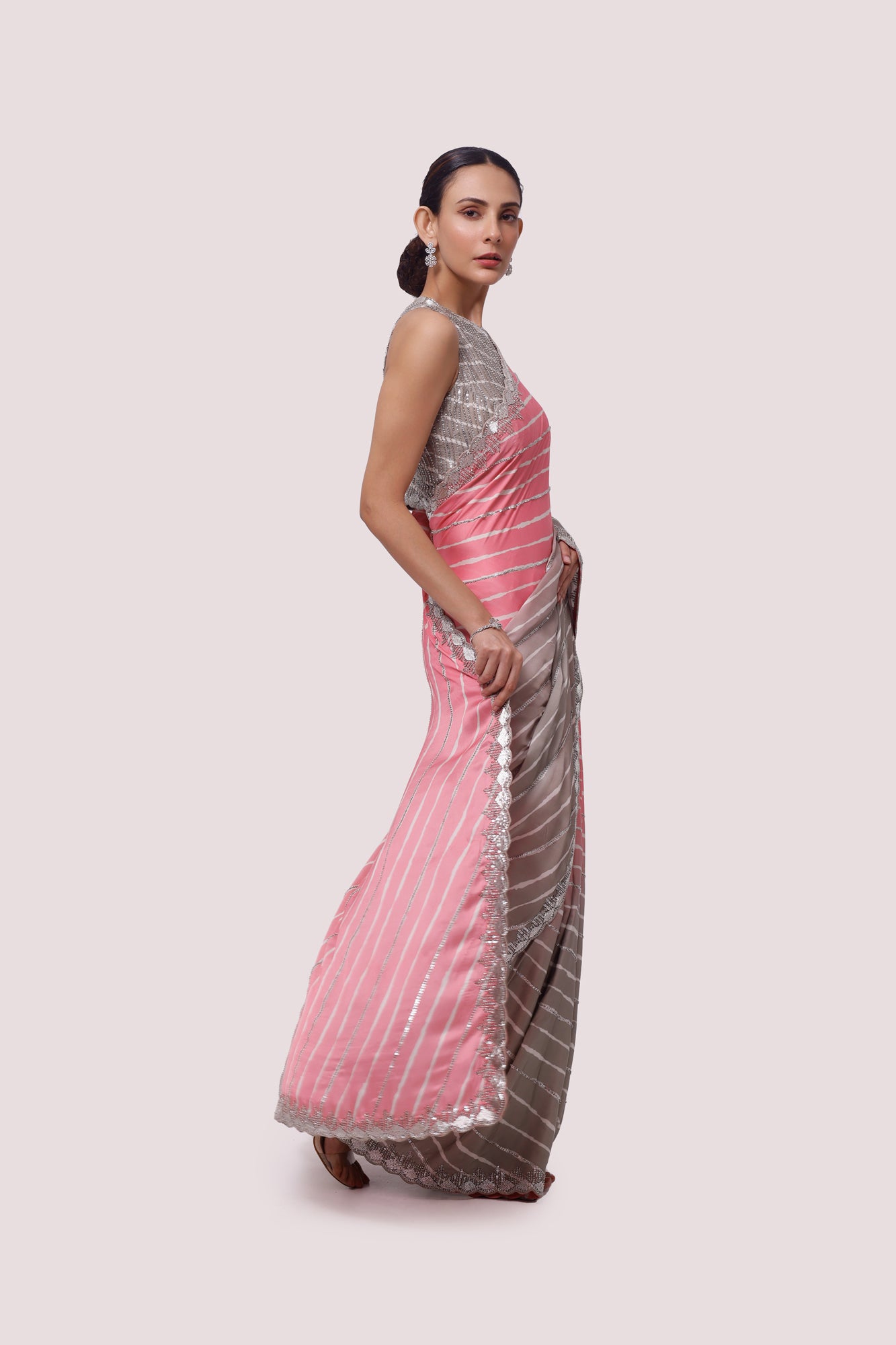 Shop ash grey and pink embellished satin saree online in USA with blouse. Make a fashion statement on festive occasions and weddings with designer sarees, designer suits, Indian dresses, Anarkali suits, palazzo suits, designer gowns, sharara suits, embroidered sarees from Pure Elegance Indian fashion store in USA.-right