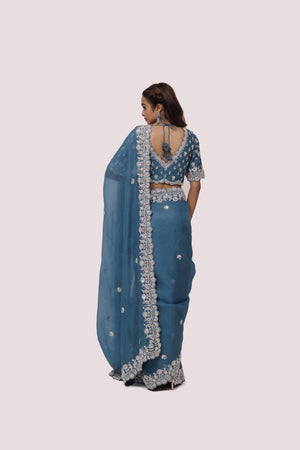 Shop sea blue embroidered organza satin saree online in USA with blouse. Make a fashion statement on festive occasions and weddings with designer sarees, designer suits, Indian dresses, Anarkali suits, palazzo suits, designer gowns, sharara suits, embroidered sarees from Pure Elegance Indian fashion store in USA.-back