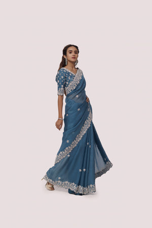 Shop sea blue embroidered organza satin saree online in USA with blouse. Make a fashion statement on festive occasions and weddings with designer sarees, designer suits, Indian dresses, Anarkali suits, palazzo suits, designer gowns, sharara suits, embroidered sarees from Pure Elegance Indian fashion store in USA.-right