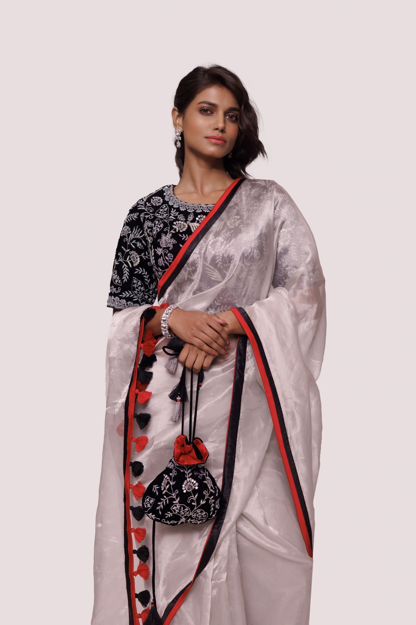 Shop grey-black organza saree featuring tikki and cut dana work, tassels embroidered velvet blouse detailing is a perfect choice for parties! It comes with a designer saree blouse. Make a fashion statement at weddings with stunning designer sarees, embroidered sarees with blouses, wedding sarees, and handloom sarees from Pure Elegance Indian fashion store in the USA.
