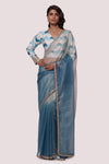 Shop An alluring blue organza saree featuring silver metallic pinstripe all over, patchwork, and sequin detailing is a perfect choice for parties! It comes with a designer saree blouse. Make a fashion statement at weddings with stunning designer sarees, embroidered sarees with blouses, wedding sarees, and handloom sarees from Pure Elegance Indian fashion store in the USA.