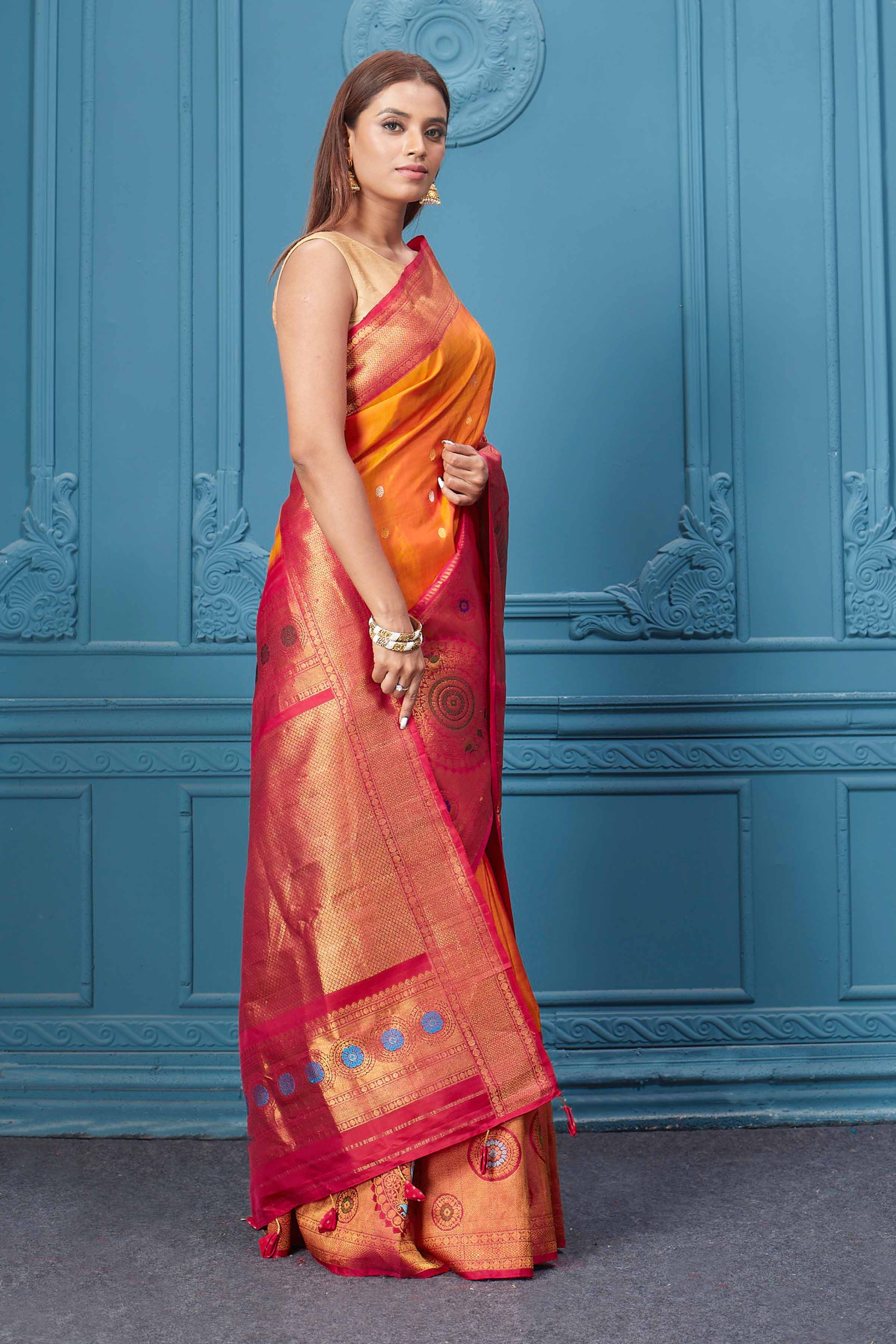 Buy orange Gadhwal silk saree online in USA with pink golden zari border. Look your best on festive occasions in latest designer sarees, pure silk saris, Kanchipuram silk sarees, handwoven sarees, tussar silk sarees, embroidered saris from Pure Elegance Indian clothing store in USA.-side