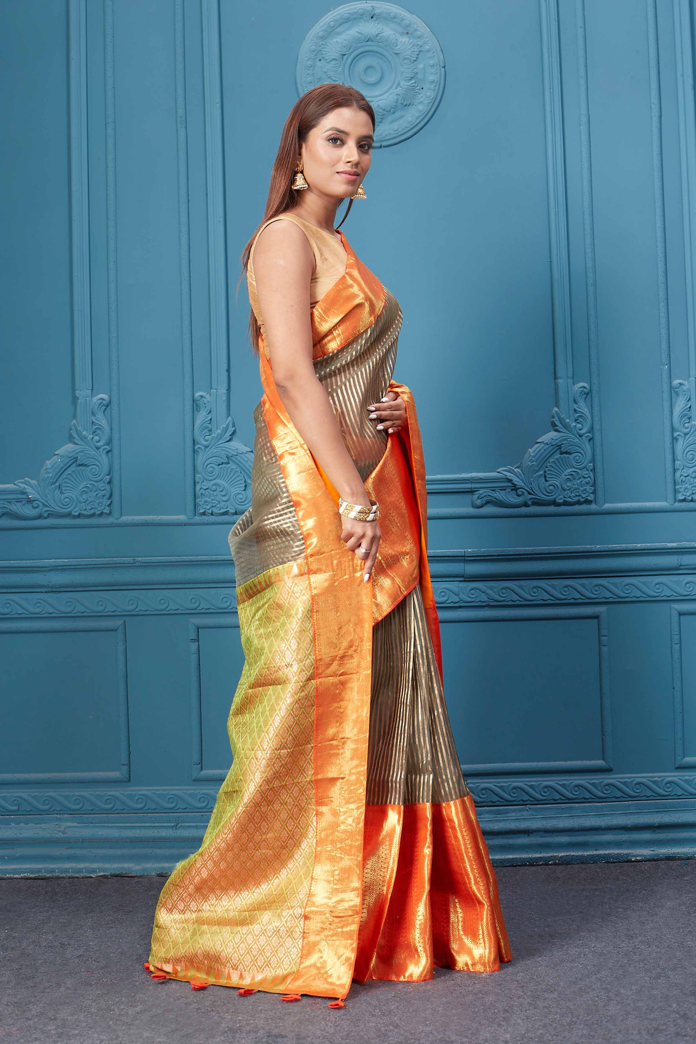 Buy brown striped Kora Kanjivaram saree online in USA with orange border. Look your best on festive occasions in latest designer sarees, pure silk saris, Kanchipuram silk sarees, handwoven sarees, tussar silk sarees, embroidered saris from Pure Elegance Indian clothing store in USA.-side
