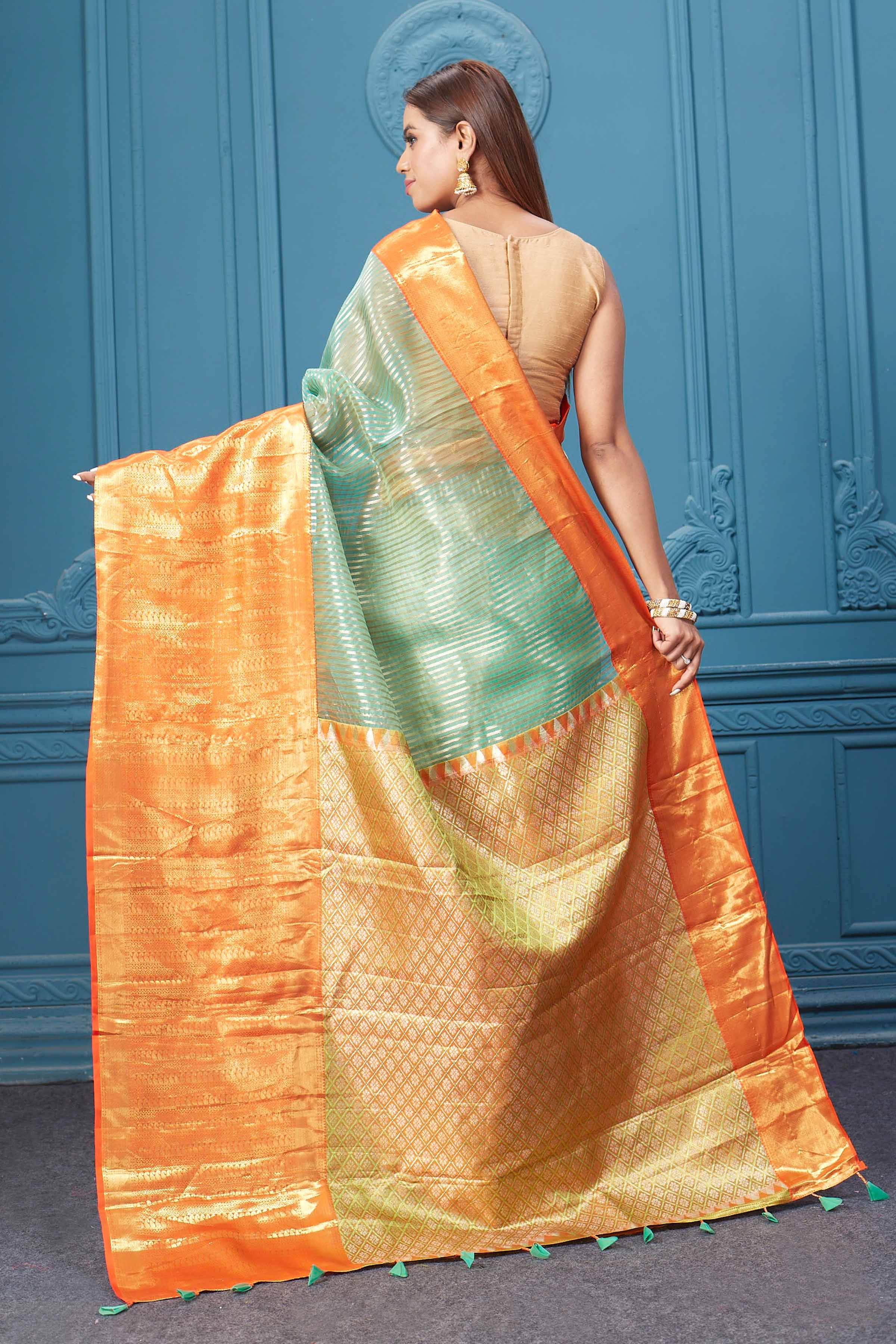Buy beautiful sea green striped Kora Kanjivaram sari online in USA with orange border. Look your best on festive occasions in latest designer sarees, pure silk saris, Kanchipuram silk sarees, handwoven sarees, tussar silk sarees, embroidered saris from Pure Elegance Indian clothing store in USA.-back
