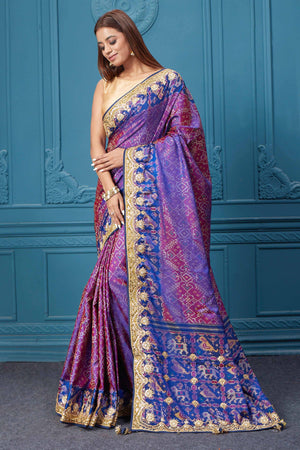 Shop stunning purple embroidered Patola silk saree online in USA. Look royal at weddings and festive occasions in exquisite designer sarees, handwoven sarees, pure silk saris, Banarasi sarees, Kanchipuram silk sarees from Pure Elegance Indian saree store in USA. -pallu