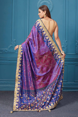 Shop stunning purple embroidered Patola silk saree online in USA. Look royal at weddings and festive occasions in exquisite designer sarees, handwoven sarees, pure silk saris, Banarasi sarees, Kanchipuram silk sarees from Pure Elegance Indian saree store in USA. -back
