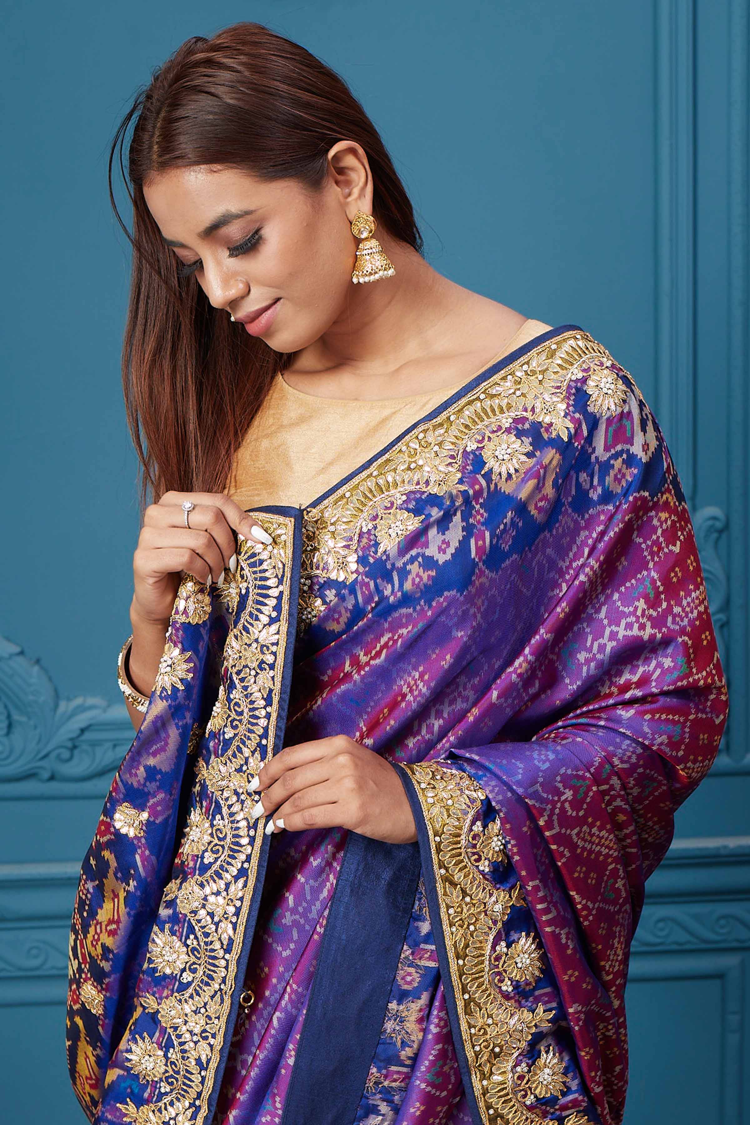 Shop stunning purple embroidered Patola silk saree online in USA. Look royal at weddings and festive occasions in exquisite designer sarees, handwoven sarees, pure silk saris, Banarasi sarees, Kanchipuram silk sarees from Pure Elegance Indian saree store in USA. -closeup