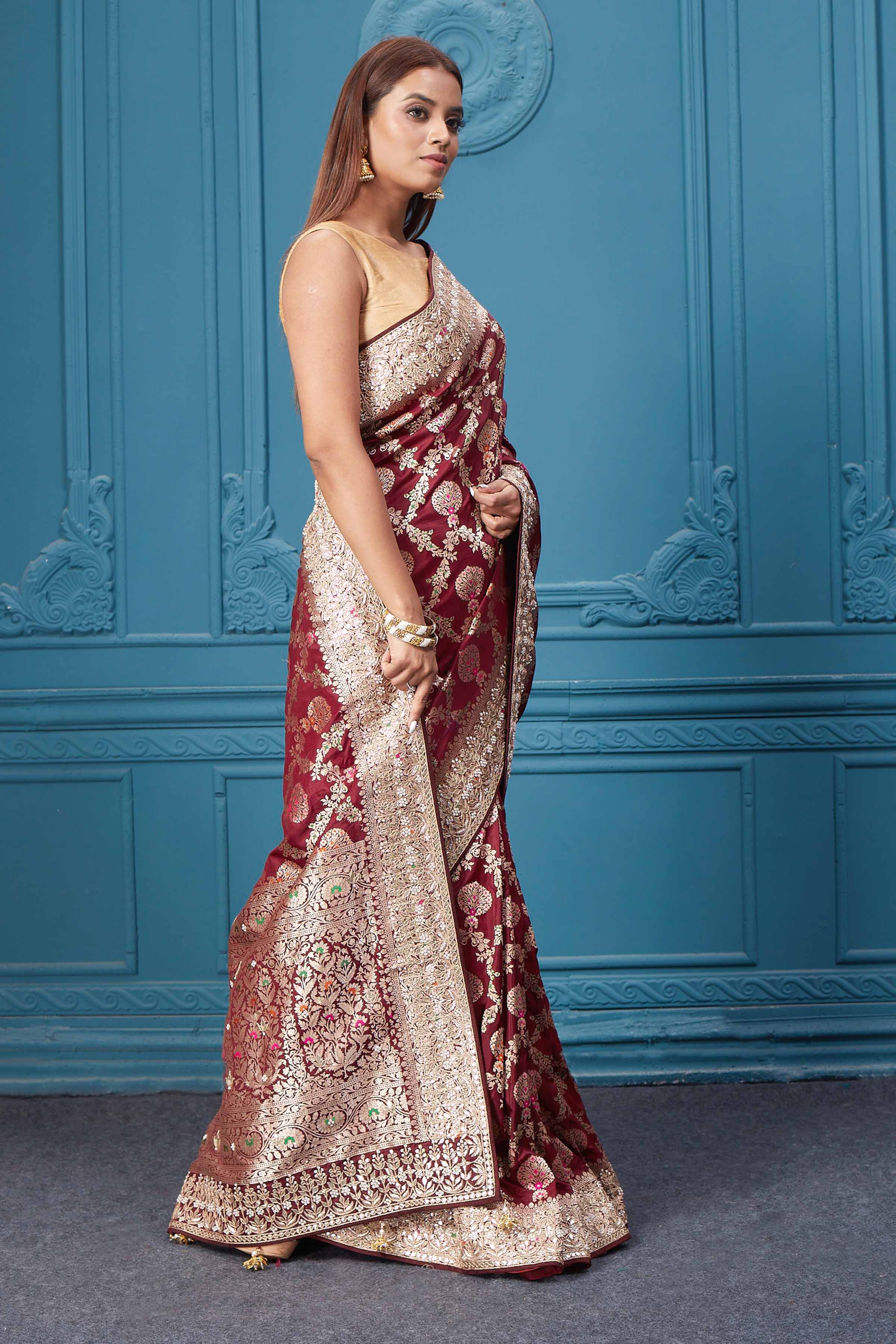 Shop stunning maroon heavy Banarasi silk saree online in USA. Look royal at weddings and festive occasions in exquisite designer sarees, handwoven sarees, pure silk saris, Banarasi sarees, Kanchipuram silk sarees from Pure Elegance Indian saree store in USA. -side