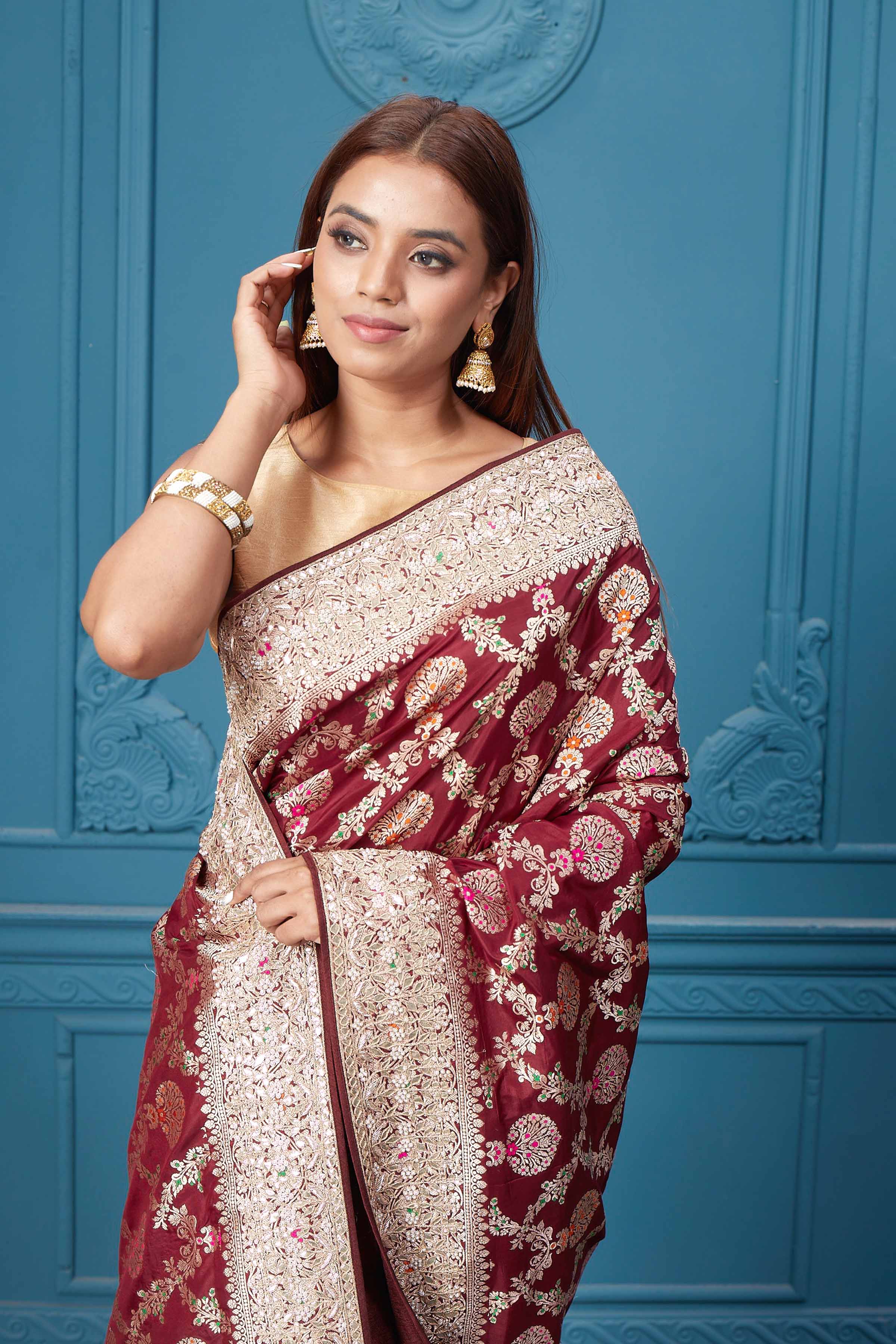 Shop stunning maroon heavy Banarasi silk saree online in USA. Look royal at weddings and festive occasions in exquisite designer sarees, handwoven sarees, pure silk saris, Banarasi sarees, Kanchipuram silk sarees from Pure Elegance Indian saree store in USA. -closeup