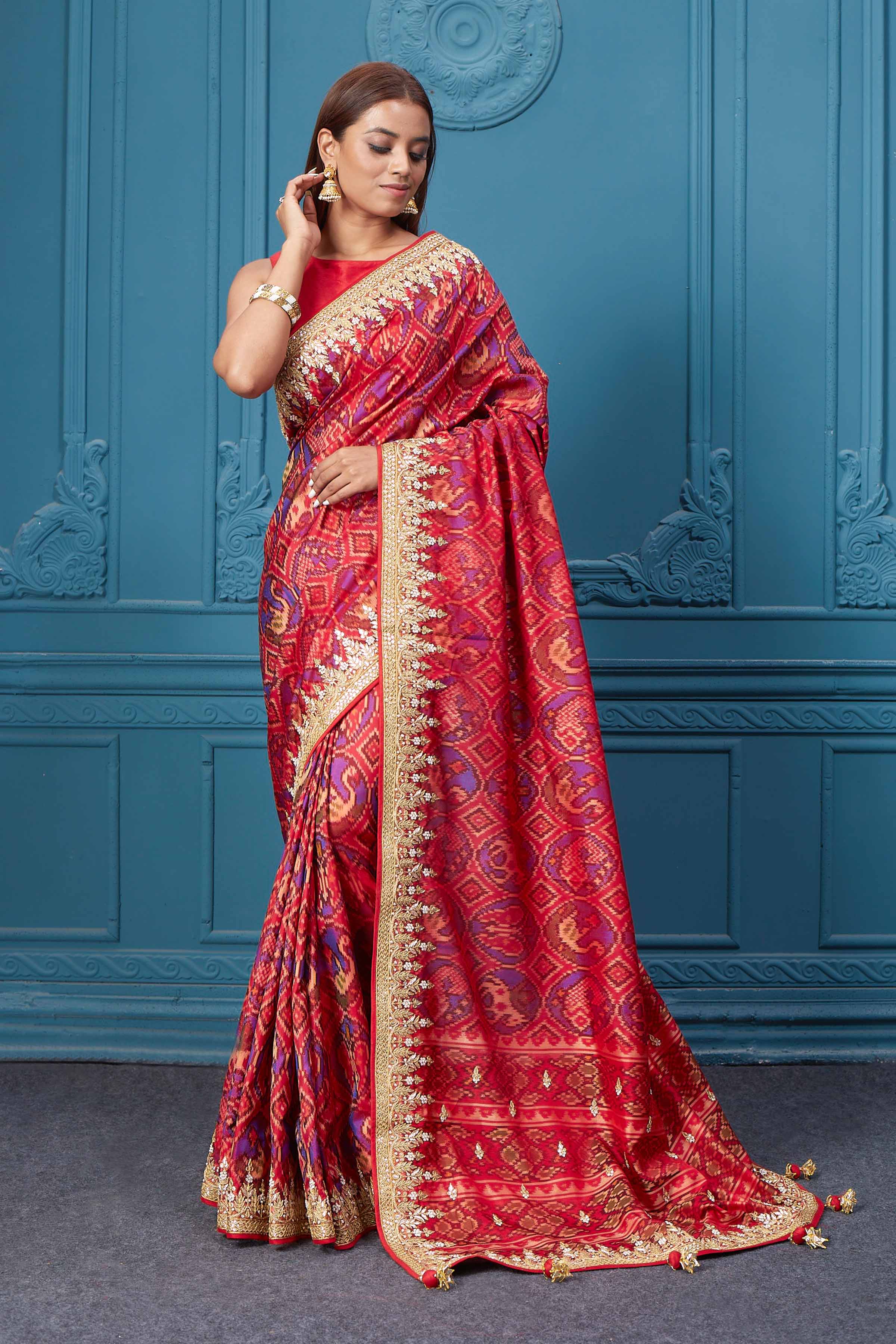 Shop stunning red embroidered Patola silk sari online in USA. Look royal at weddings and festive occasions in exquisite designer sarees, handwoven sarees, pure silk saris, Banarasi sarees, Kanchipuram silk sarees from Pure Elegance Indian saree store in USA. -pallu