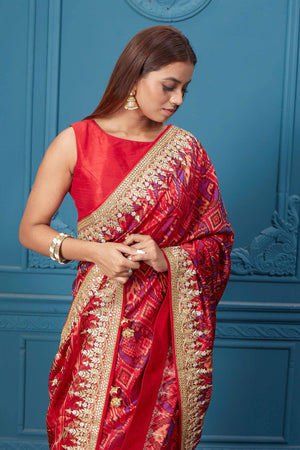 Shop stunning red embroidered Patola silk sari online in USA. Look royal at weddings and festive occasions in exquisite designer sarees, handwoven sarees, pure silk saris, Banarasi sarees, Kanchipuram silk sarees from Pure Elegance Indian saree store in USA. -closeup
