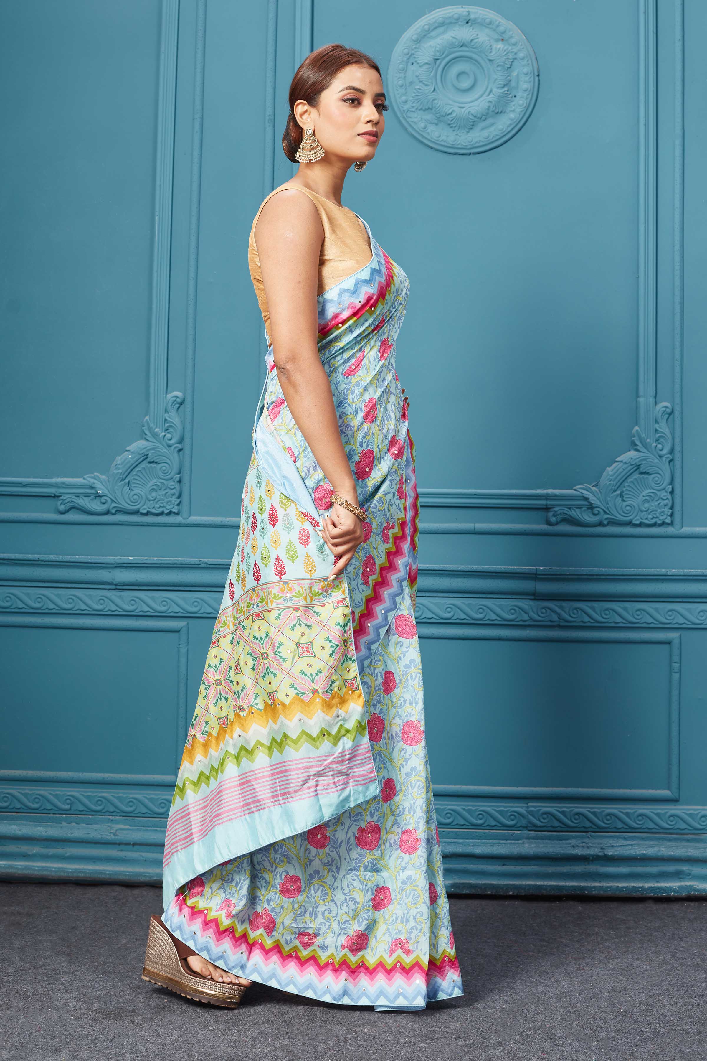 Shop powder blue floral embroidered mulberry silk saree online in USA. Look royal at weddings and festive occasions in exquisite designer sarees, handwoven sarees, pure silk saris, Banarasi sarees, Kanchipuram silk sarees from Pure Elegance Indian saree store in USA. -side