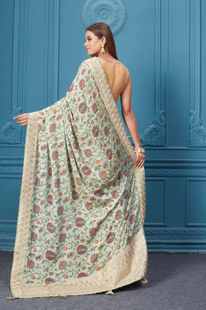 Buy sage green printed and embroidered crepe silk sari online in USA with saree blouse. Look royal at weddings and festive occasions in exquisite designer sarees, handwoven sarees, pure silk saris, Banarasi sarees, Kanchipuram silk sarees from Pure Elegance Indian saree store in USA. -back