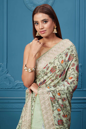 Buy sage green printed and embroidered crepe silk sari online in USA with saree blouse. Look royal at weddings and festive occasions in exquisite designer sarees, handwoven sarees, pure silk saris, Banarasi sarees, Kanchipuram silk sarees from Pure Elegance Indian saree store in USA. -closeup