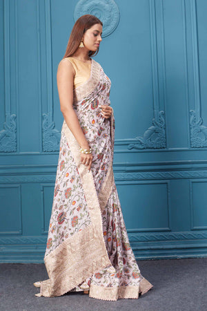 Shop powder pink floral crepe silk sari online in USA with saree blouse. Look royal at weddings and festive occasions in exquisite designer sarees, handwoven sarees, pure silk saris, Banarasi sarees, Kanchipuram silk sarees from Pure Elegance Indian saree store in USA. -side