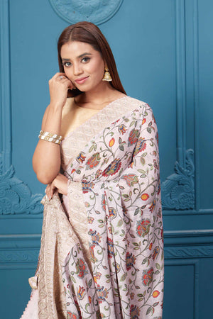 Shop powder pink floral crepe silk sari online in USA with saree blouse. Look royal at weddings and festive occasions in exquisite designer sarees, handwoven sarees, pure silk saris, Banarasi sarees, Kanchipuram silk sarees from Pure Elegance Indian saree store in USA. -closeup