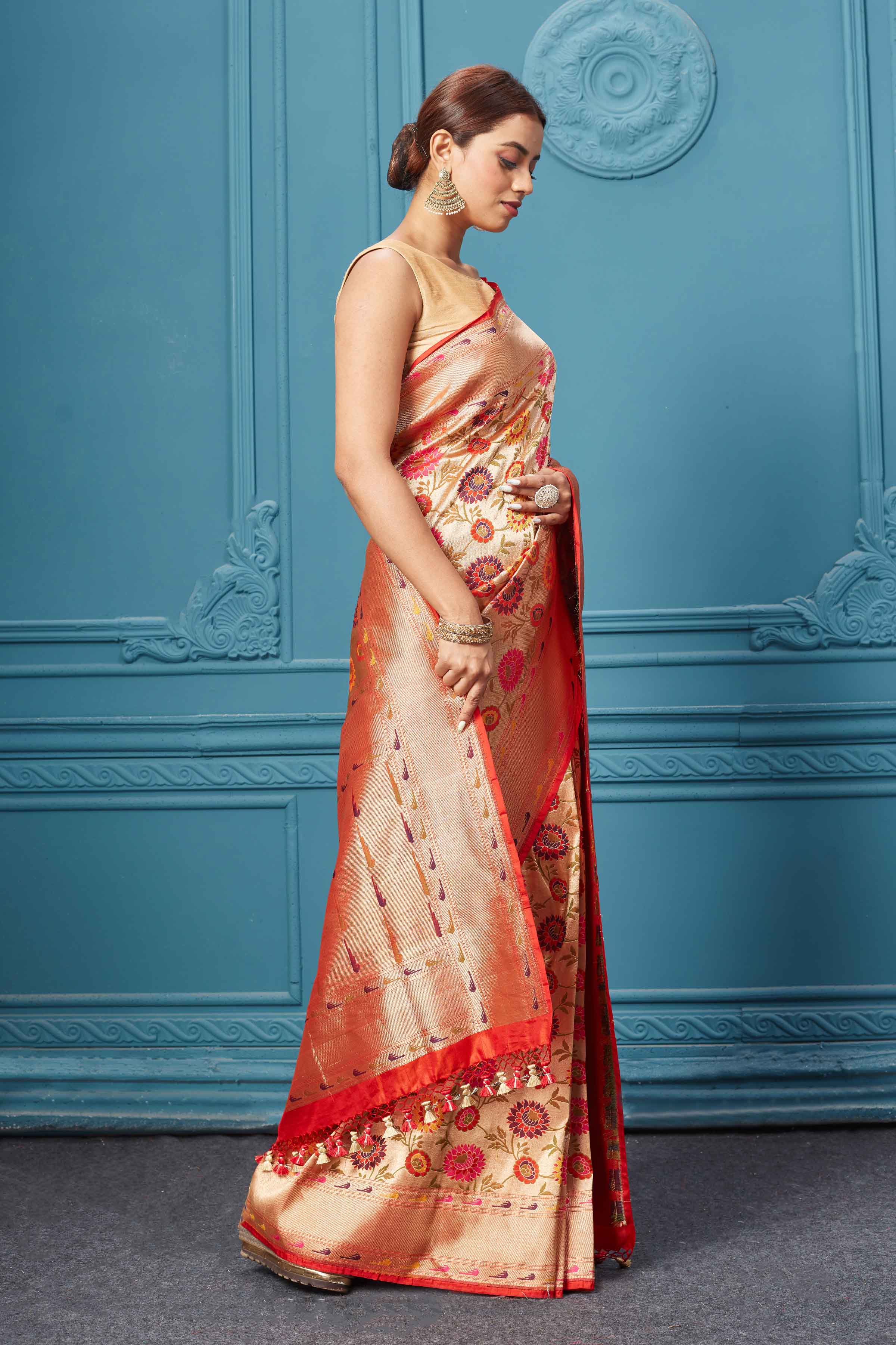 Shop golden Katan silk Banarasi sari online in USA with floral jaal. Keep your ethnic wardrobe up to date with latest designer saris, pure silk sarees, Kanchipuram silk sarees, handwoven silk sarees, tussar silk sarees, embroidered sarees from Pure Elegance Indian saree store in USA.-side